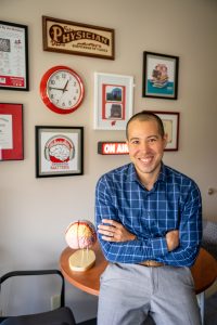 Man stands in front of radio on air sign
