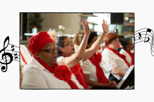 Chorus members singing, arms raised in air
